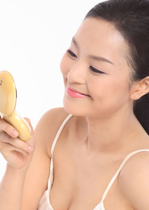 Woman smiling while considering the placement of a cheek dimple